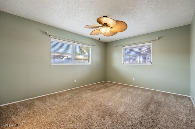 carpeted empty room with a textured ceiling and ceiling fan