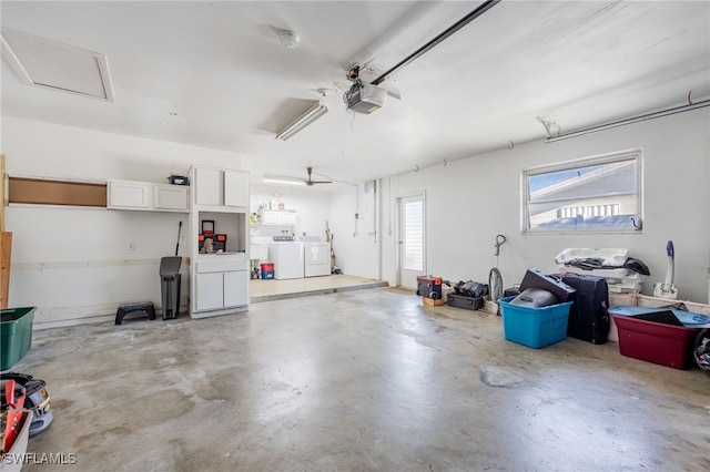 garage featuring washer and clothes dryer and a garage door opener