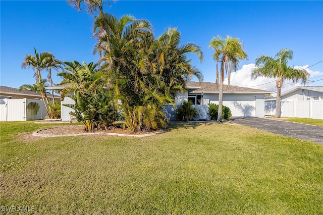 view of front of house with a front yard and a garage