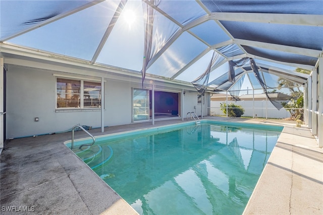 view of swimming pool with a lanai and a patio area