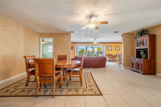 dining room with light tile patterned flooring and a textured ceiling