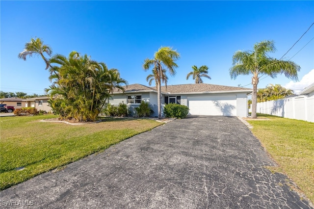 single story home with a front yard and a garage