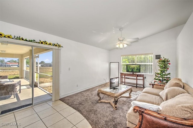 tiled living room featuring ceiling fan, a wealth of natural light, and vaulted ceiling