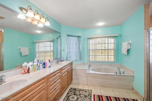 bathroom with tile patterned flooring, vanity, shower with separate bathtub, and a wealth of natural light