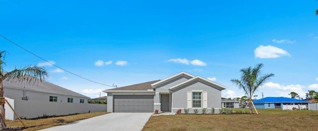 view of front of house with a front yard and a garage