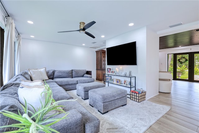 living room featuring french doors, light hardwood / wood-style floors, and ceiling fan