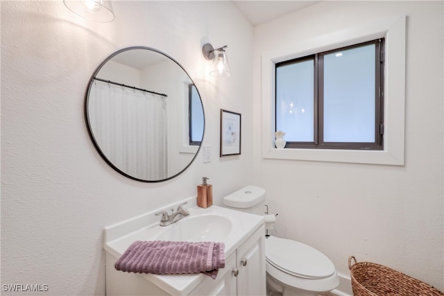 bathroom with vanity and toilet