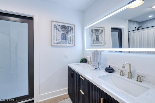 bathroom with vanity, hardwood / wood-style flooring, and curtained shower