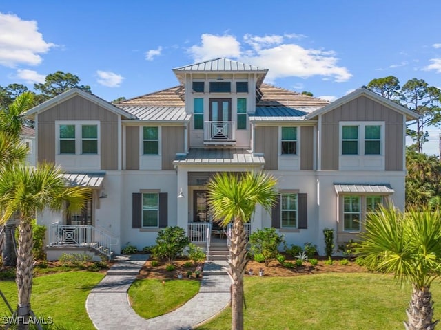 view of front of house with covered porch and a front lawn