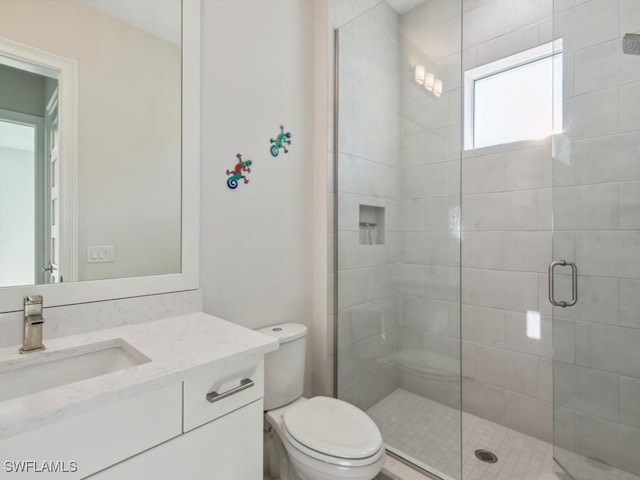 bathroom with vanity, toilet, and walk in shower