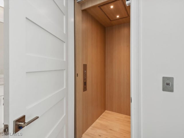 details featuring elevator and wooden walls