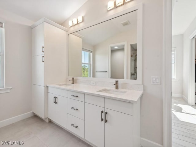 bathroom with vanity and vaulted ceiling