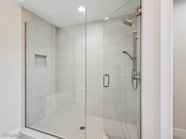 bathroom featuring a shower with shower door