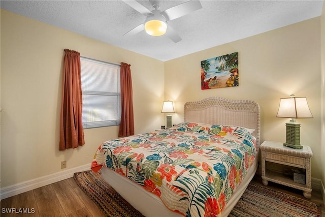 bedroom featuring wood-type flooring, a textured ceiling, and ceiling fan