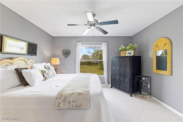 carpeted bedroom with a ceiling fan, a textured ceiling, and baseboards