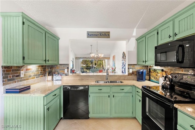 kitchen featuring light tile patterned floors, tasteful backsplash, a textured ceiling, black appliances, and a sink