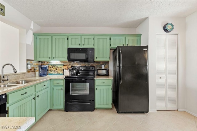 kitchen featuring black appliances, light tile patterned floors, decorative backsplash, and a sink