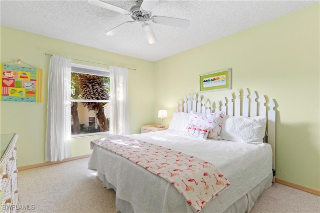 bedroom featuring a ceiling fan, carpet, baseboards, and a textured ceiling