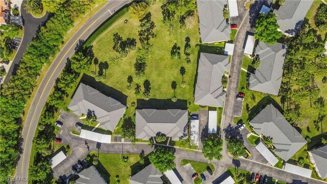 birds eye view of property with a residential view