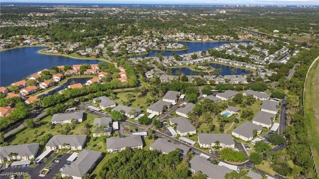 birds eye view of property with a water view and a residential view