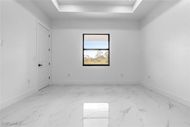 spare room featuring a tray ceiling