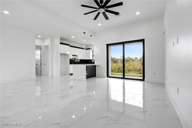 unfurnished living room with ceiling fan