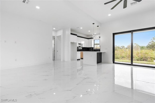 unfurnished living room with ceiling fan