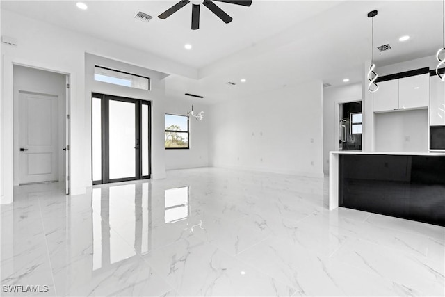 unfurnished living room featuring ceiling fan