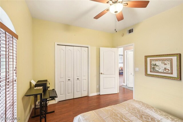 bedroom featuring dark hardwood / wood-style floors, a closet, and ceiling fan