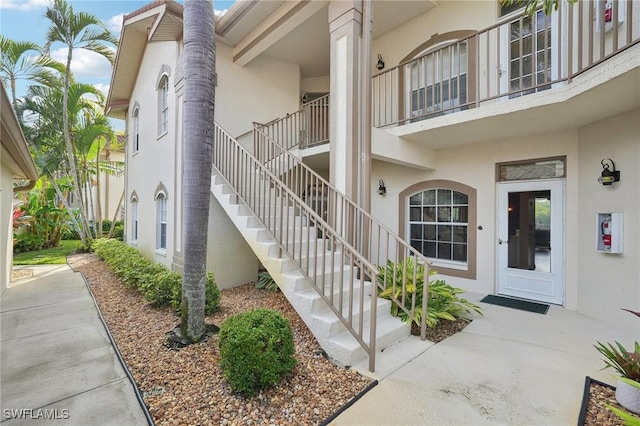 242 Newport Dr Unit 502, Naples, FL 34114 - doorway to property featuring stucco siding