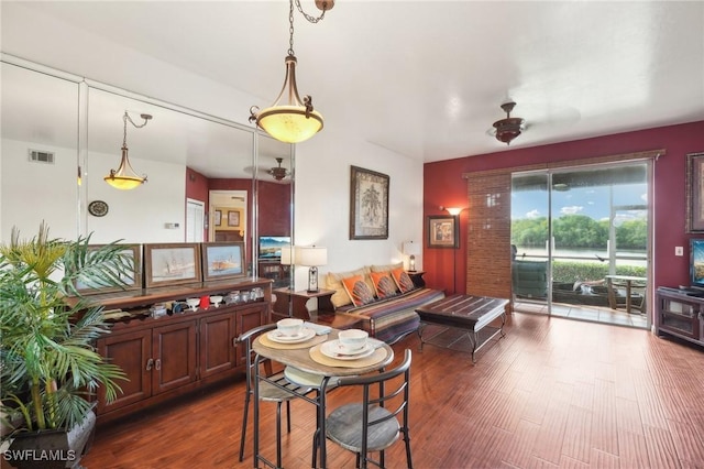 dining space with dark wood-type flooring and visible vents