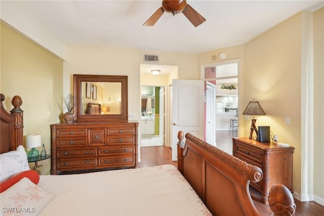 242 Newport Dr Unit 502, Naples, FL 34114 - bedroom featuring visible vents, connected bathroom, ceiling fan, and wood finished floors