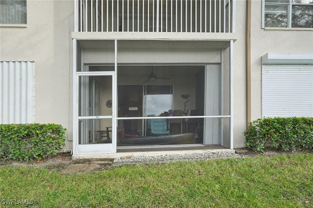 242 Newport Dr Unit 502, Naples, FL 34114 - view of exterior entry featuring stucco siding and a balcony