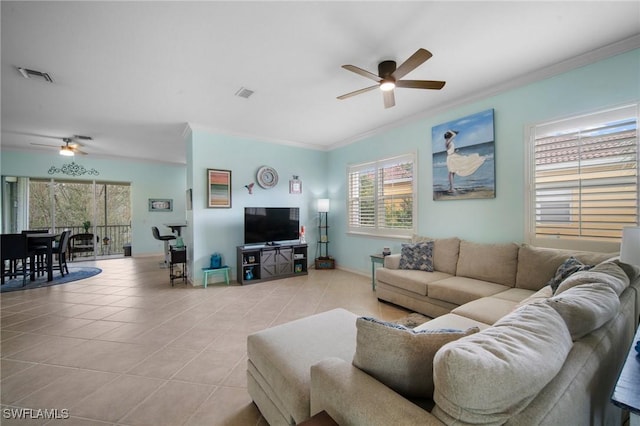 tiled living room with ceiling fan and ornamental molding