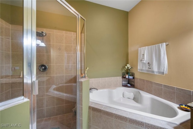 bathroom featuring separate shower and tub