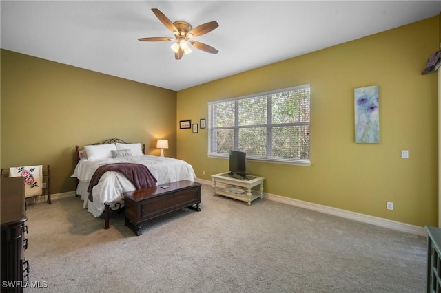 bedroom featuring ceiling fan and light carpet