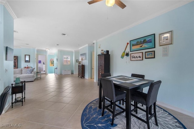 dining room with crown molding, light tile patterned floors, and ceiling fan