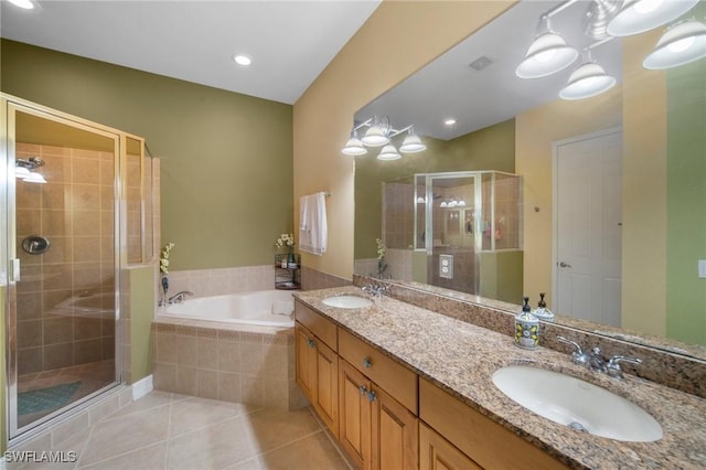 bathroom featuring tile patterned floors, vanity, and shower with separate bathtub