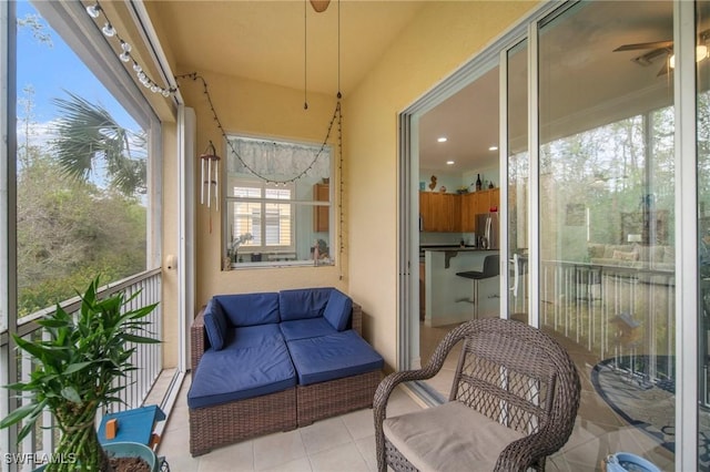 sunroom featuring a wealth of natural light and ceiling fan