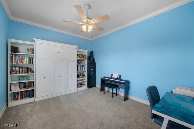 carpeted home office featuring ceiling fan and crown molding