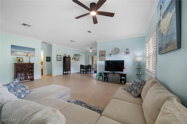 tiled living room with ceiling fan and ornamental molding