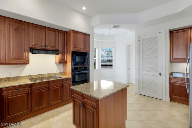 kitchen with a chandelier, light stone counters, pendant lighting, and black appliances