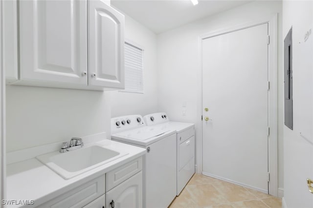 clothes washing area featuring cabinets, washing machine and dryer, and sink