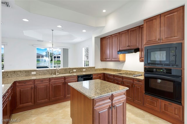 kitchen with sink, kitchen peninsula, pendant lighting, a tray ceiling, and black appliances