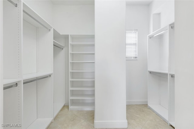 spacious closet with light tile patterned floors