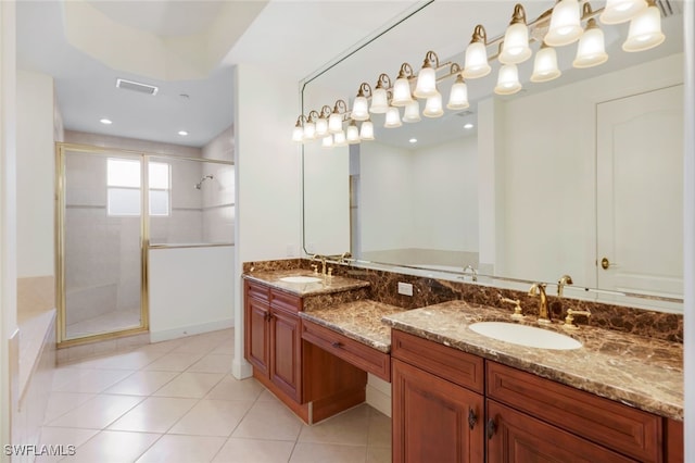 bathroom with tile patterned flooring, vanity, and walk in shower