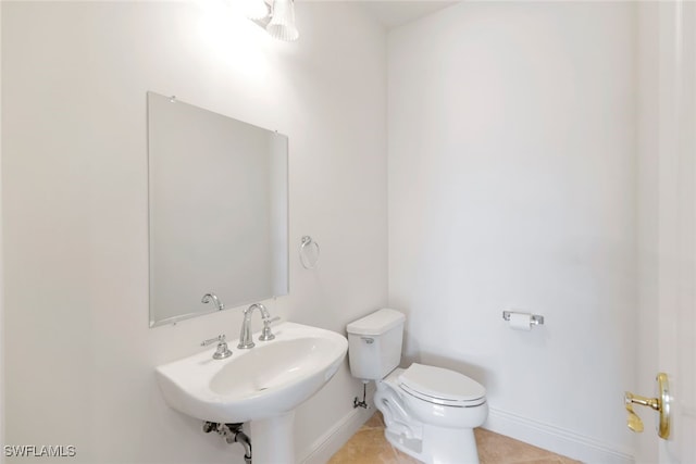 bathroom with tile patterned floors, sink, and toilet