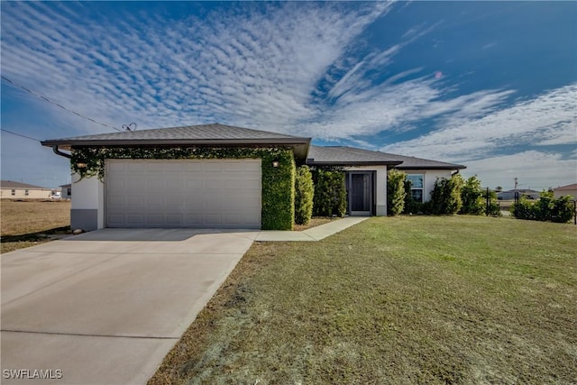 view of front of home featuring a garage and a front lawn