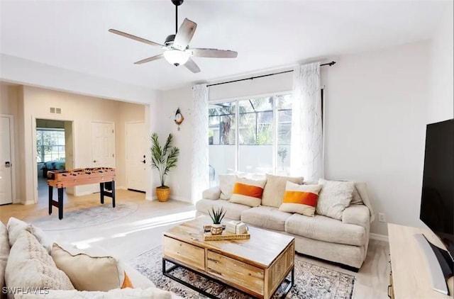 living room with plenty of natural light and ceiling fan