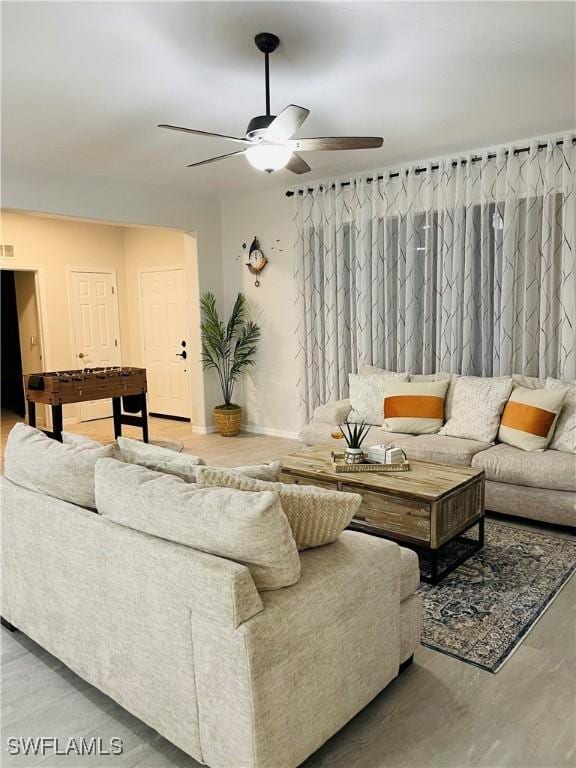 living room with hardwood / wood-style floors and ceiling fan